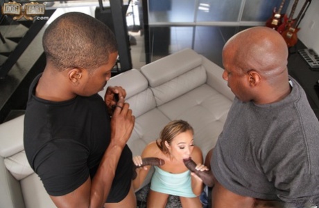 Two big black dicks intercede on a leggy blonde and give her a double sex.