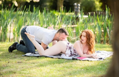 On the verge of sexual intercourse Ella Hughes, a natural redhead, drips champagne from her tongue after sex on the back lawn.