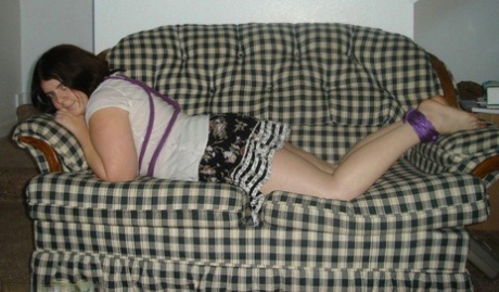 For example, an overweight girl has her hands tucked behind the back and her ankles tied.