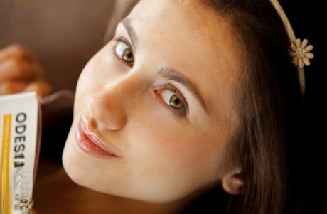 Danish, a beautiful girl who is only 15, removes her hair from the blue dress to go in an open hammock on a sofa.