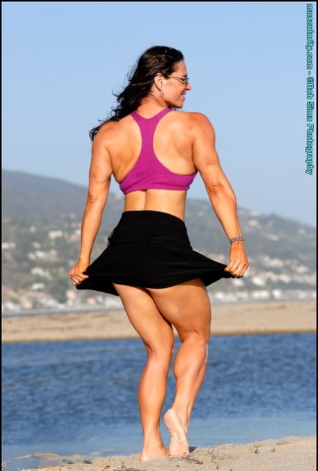 Brunette Bodybuilder Lada Phihalova Flexes On A Beach While Wearing Sunglasses