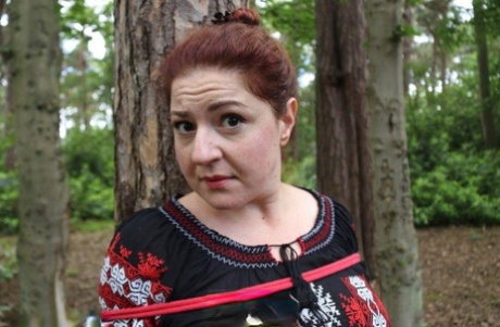 Thick Redhead Is Cleave Gagged And Tied To A Tree In A Forest