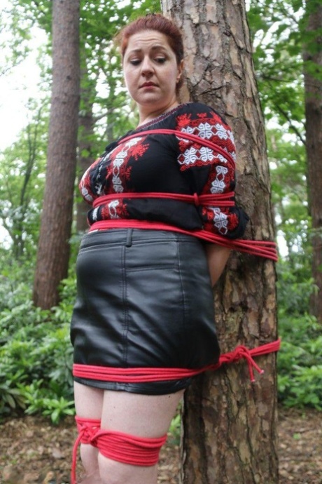 Thick Redhead Is Cleave Gagged And Tied To A Tree In A Forest
