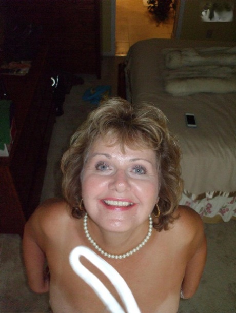 In her pantyhose, Busty Bliss, an older woman who is not professional, exhibits her boobs that are tinted brown.