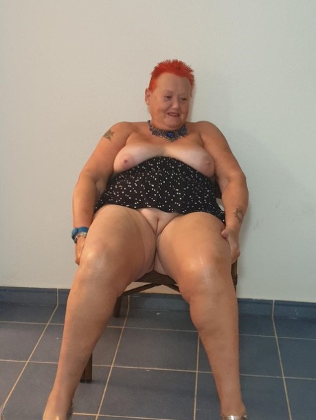 Fat Nan With Short Red Hair Presses Her Big Boobs And Butt Up Against Glass