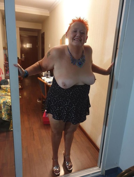 Fat Nan With Short Red Hair Presses Her Big Boobs And Butt Up Against Glass