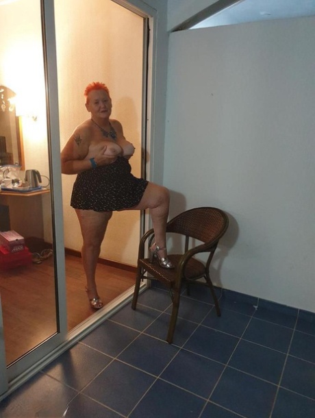 Fat Nan With Short Red Hair Presses Her Big Boobs And Butt Up Against Glass