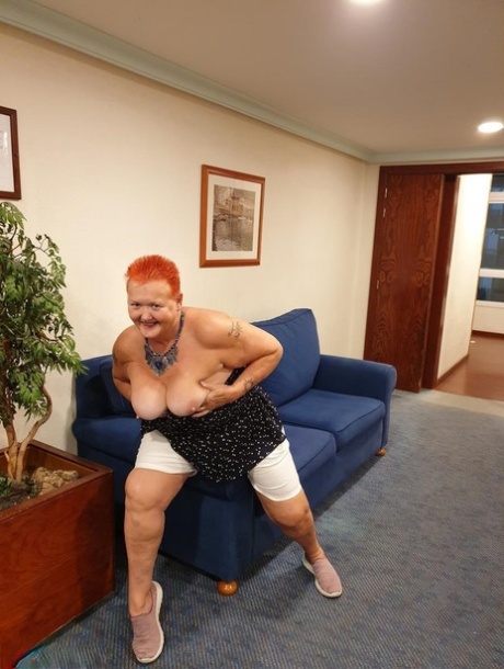 Fat Nan With Short Red Hair Presses Her Big Boobs And Butt Up Against Glass