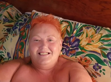 At home, a fat woman with red hair takes nude selfies and goes by the name Valgasmic Exposed.