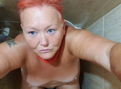 Valgasmic Exposed captures nude selfies from the comfort of her home, a fat woman with red hair.