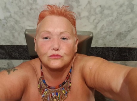 Selfies at home: The overweight woman with red hair goes for nude photos while on vacation.
