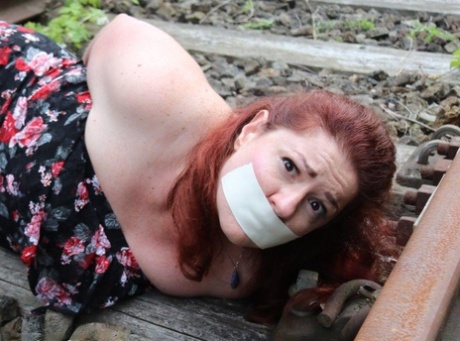 Natural Redhead Is Left Hog Tied And Gagged On Railway Tracks