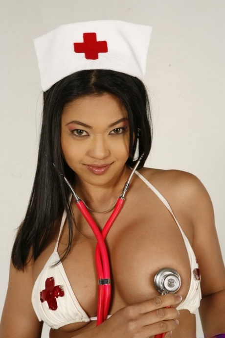 In her first nude poses, the Asian nurse wears red stockings.