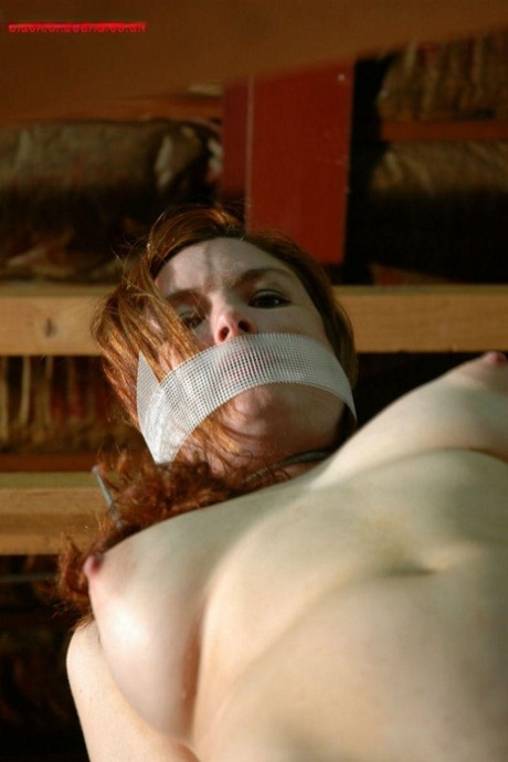 Nude Redhead Loses Her Gag While Restrained With Rope In A Warehouse