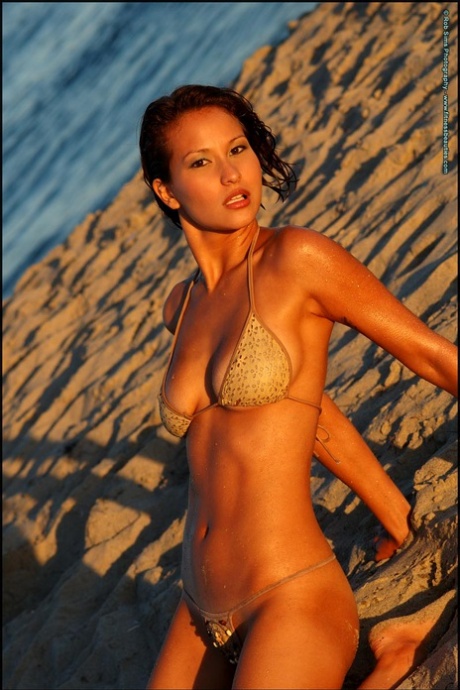 Asian beauty Angela Blair is captured in a bikini on the beach.