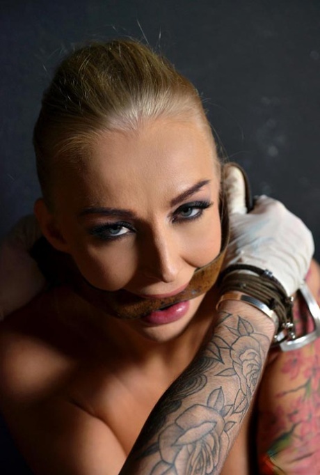 Teenage girl Kayla Green gets restrained and pulled around by a tattoo artist.