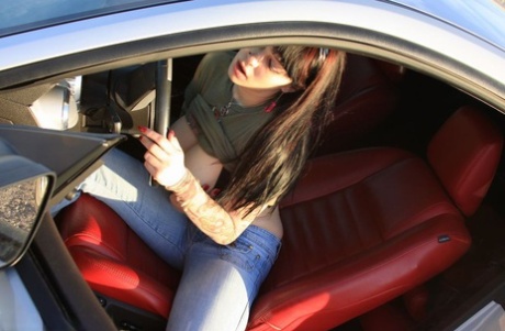 Despite being an amateur girl, Susy Rocking flip-flops the bird while hiding her massive breast in a car.