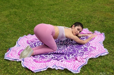 In her twats, Gianna Gem, a non-professional yoga enthusiast, uses a baseball bat after practicing yoga outside.