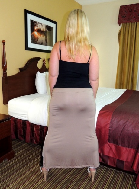 Ahead of having sex on a bed, Dee Siren displays her substantial buttocks.