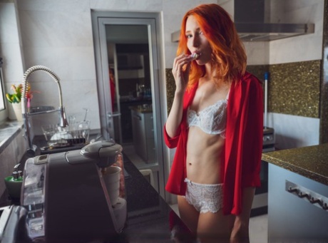 Over a hot drink, Elin Dane the young redhead goes completely naked on her bed.