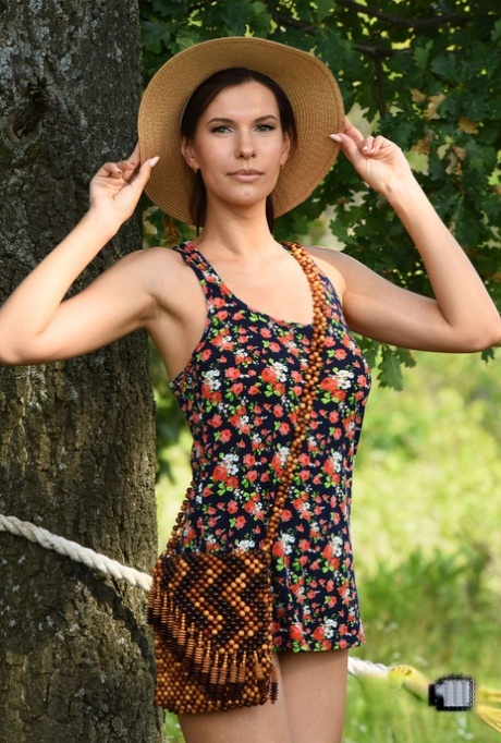 Leggy teen Susi R ditches a sun hat and dress to lay totally nude on a hammock