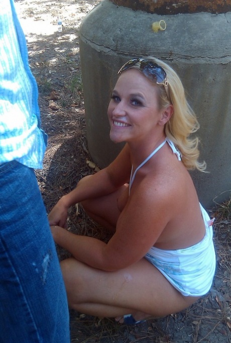 On the run: Blonde amateur Dee Siren gets caught on camera having'sexually suggestive' sexual activity in public park.