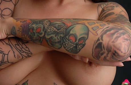 During closeups, Emily Parker showcases her heavily tattooed body as a solo model.