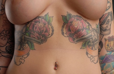 At closeups, Emily Parker displays her heavily tattooed body as a model for solo artists.