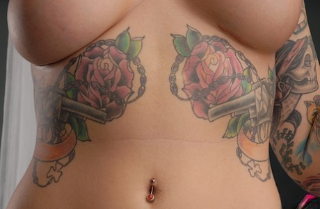 In closeups, Emily Parker showcases her tattooed physique as a solo model.