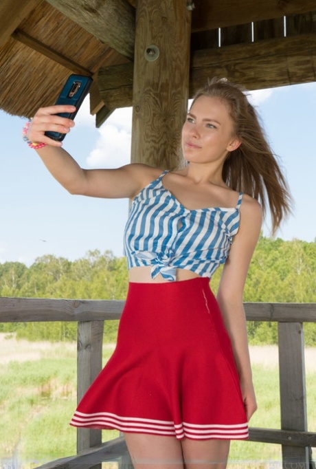 Petite teen Merelin takes selfies while getting naked at a wildlife lookout
