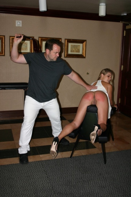 Two girls with big buttocks are paddled over BDSM benches by an undressed man.