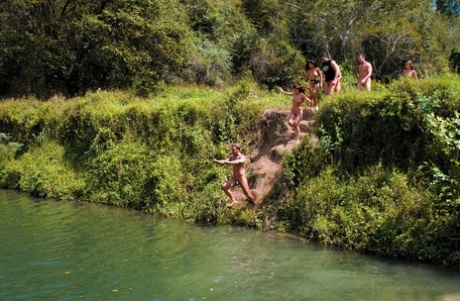 A tropical beach is where a group of attractive girls engage in sexual activities together.