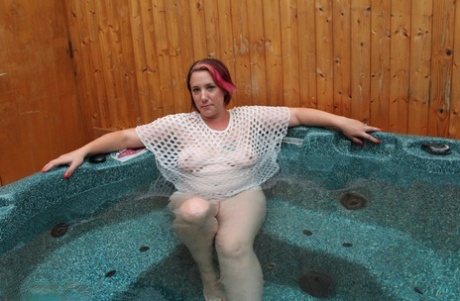 While in an outdoor hot tub, a pluck amateur removes a mesh top.