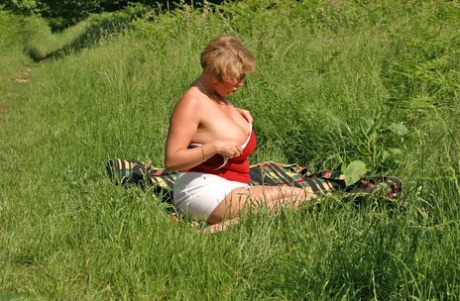 The large tits and big butts of Curvy Claire, an obese woman, are observed in a field.