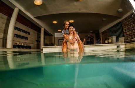 Young and old, lesbians have a sexual encounter within an indoor swimming pool.