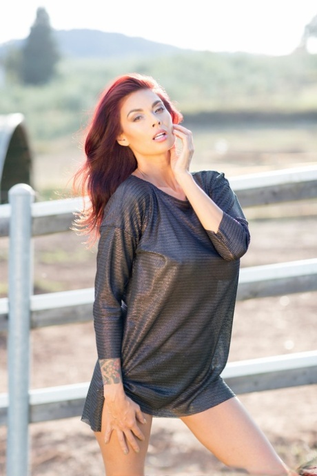 Asian beauty Tera Patrick flashes her black panties by a fence on a farm