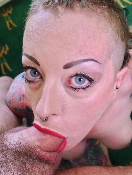 Piggy Mouth, a female with tattooed belly and penis, has a tendency to slurp on a dick before engaging in sexual activity.