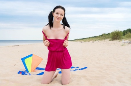 Little blonde Stacy goes kite surfing at the beach while completely naked.