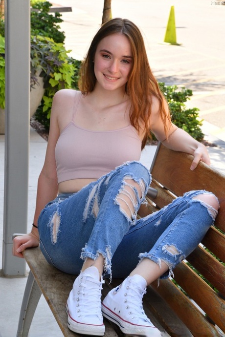 Without clothes: Natural redhead Hazel stretches out on the veranda before playing around with her pussy pink face.