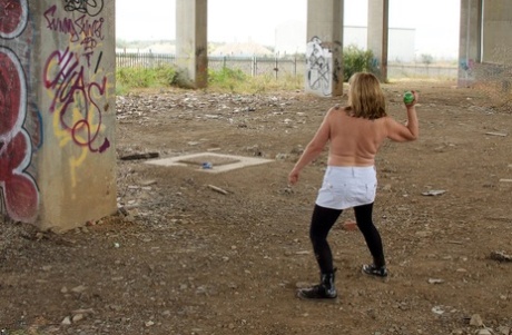 UK's homeless woman, Speedy Bee (pictured), shows off her breasts in a shopping cart.