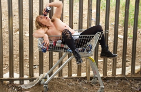 UK resident Speedy Bee is seen with her breasts in a shopping cart, having lost all of her possessions for convenience.