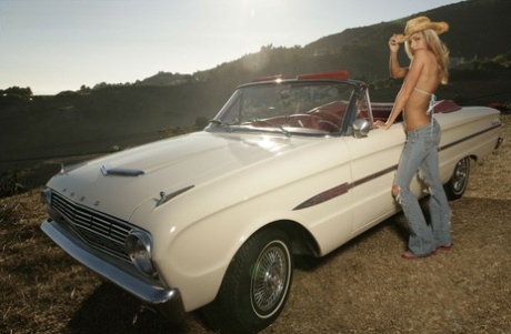 Layla Taylor, a stunning blonde, exits the convertible with a hat and ripped jeans.