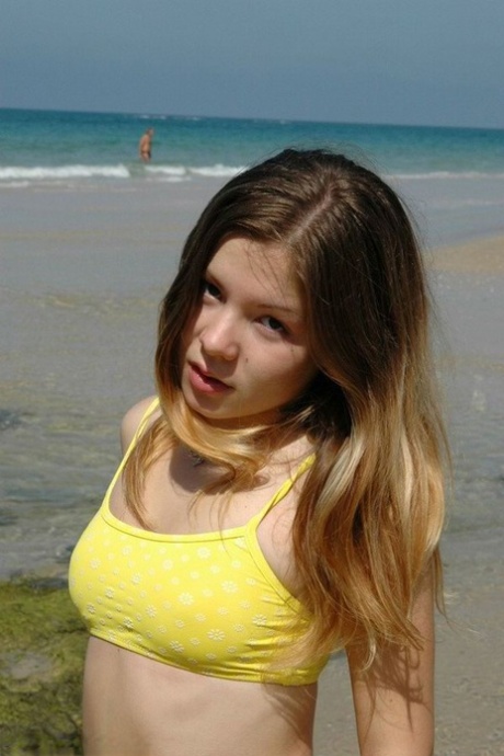 Charming 18 Year Old Models A Yellow Bikini While At The Beach