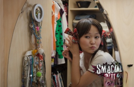 Asian girl student Aliona, who appears young but unattached at the time, wears pigtails and goes nude.