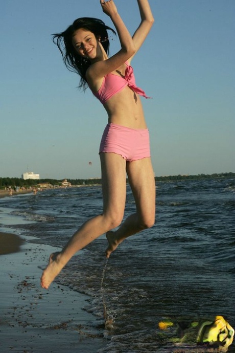 An amateur girl loses her small fidgety while participating in seaside action.