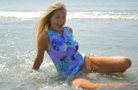 Natural blonde teen makes her nude debut while searching for shells at the sea