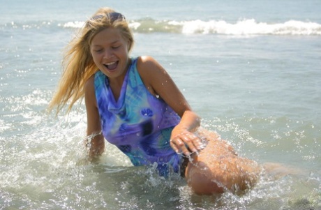 Natural blonde teen makes her nude debut while searching for shells at the sea