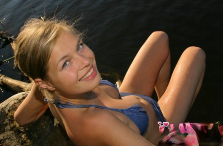 Beautiful blonde teen takes off her bikini while at the lake