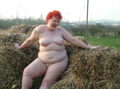 An aged reddest person, known as Valgasmic Exposed, rolls around naked in a covered mud pit.