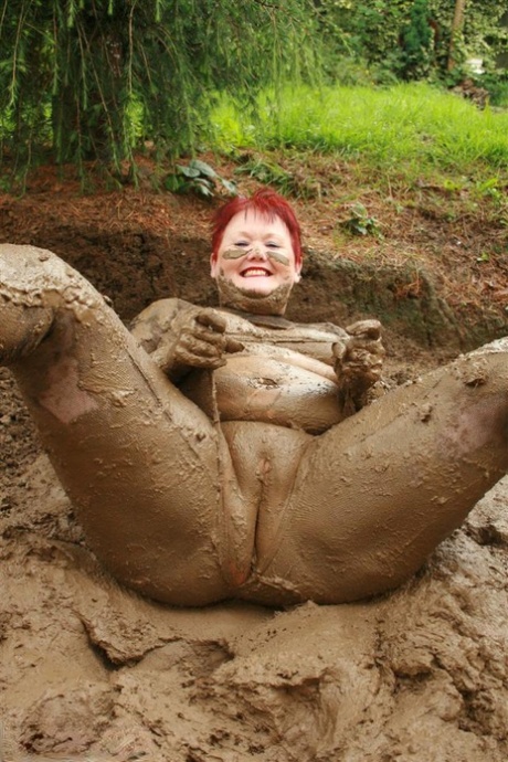 An elderly Redhead named Valgasmic Exposed is seen pooping in the middle of a pit.
